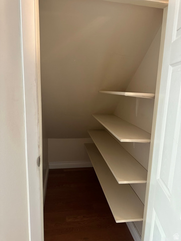 254 Meadow Lane Centerville, UT 84014 - Photo 17 of 34 Built-in shelving within a sloped storage area with wood-finish flooring and light-toned walls