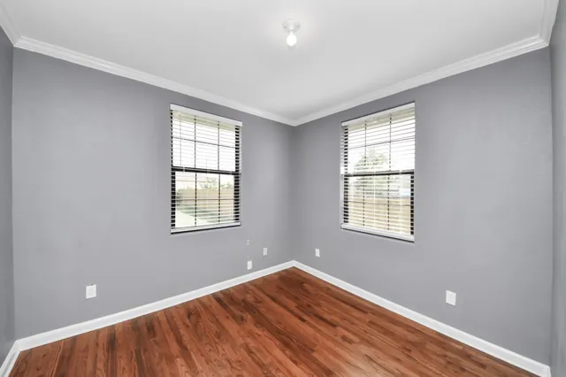 wooden floor in an empty room with a window