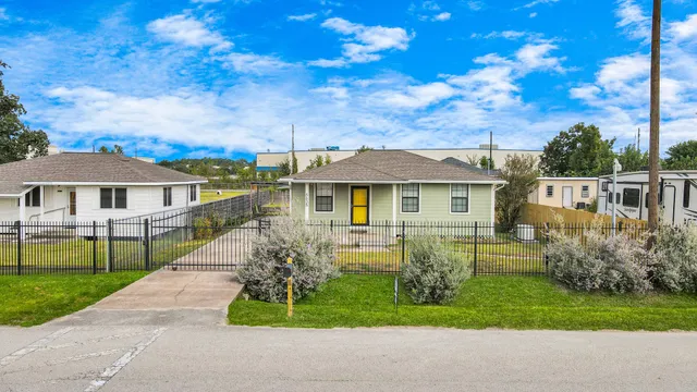 a front view of house with yard and green space