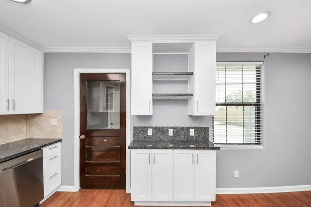 a kitchen with stainless steel appliances a stove a microwave and cabinets