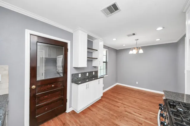 a kitchen with stainless steel appliances kitchen island granite countertop a stove and a sink