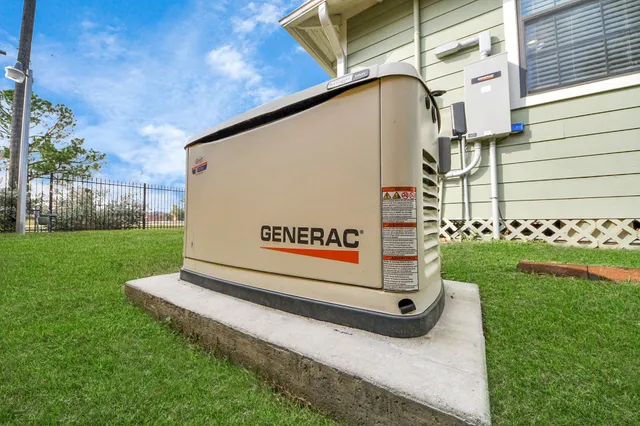 a sign board with a house in the background