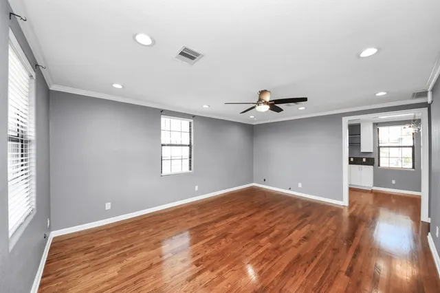wooden floor in an empty room with a window