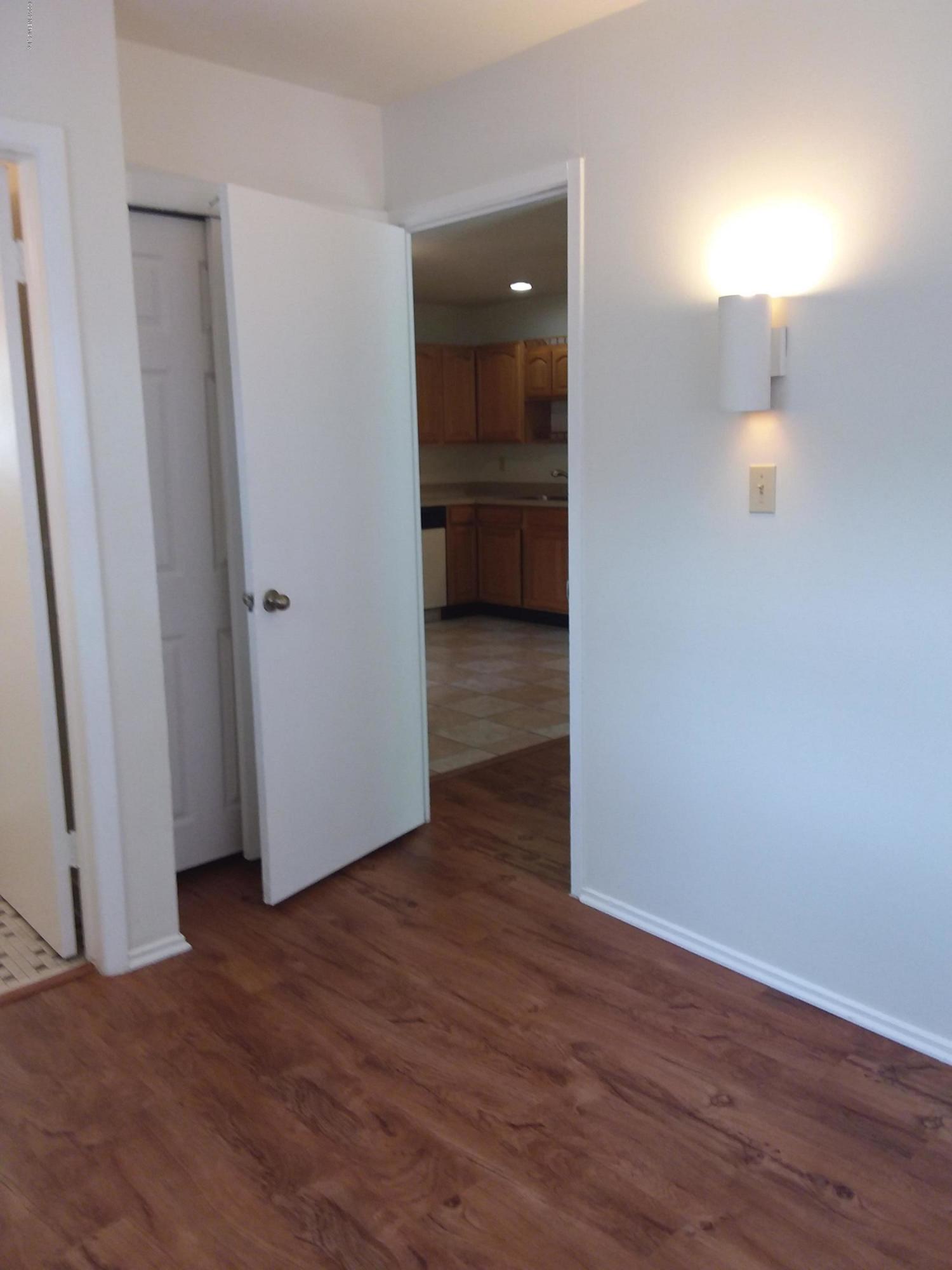 7311 Melvin Road Jacksonville, FL 32210 - Photo 12 of 24 a view of a room with wooden floor and entrance