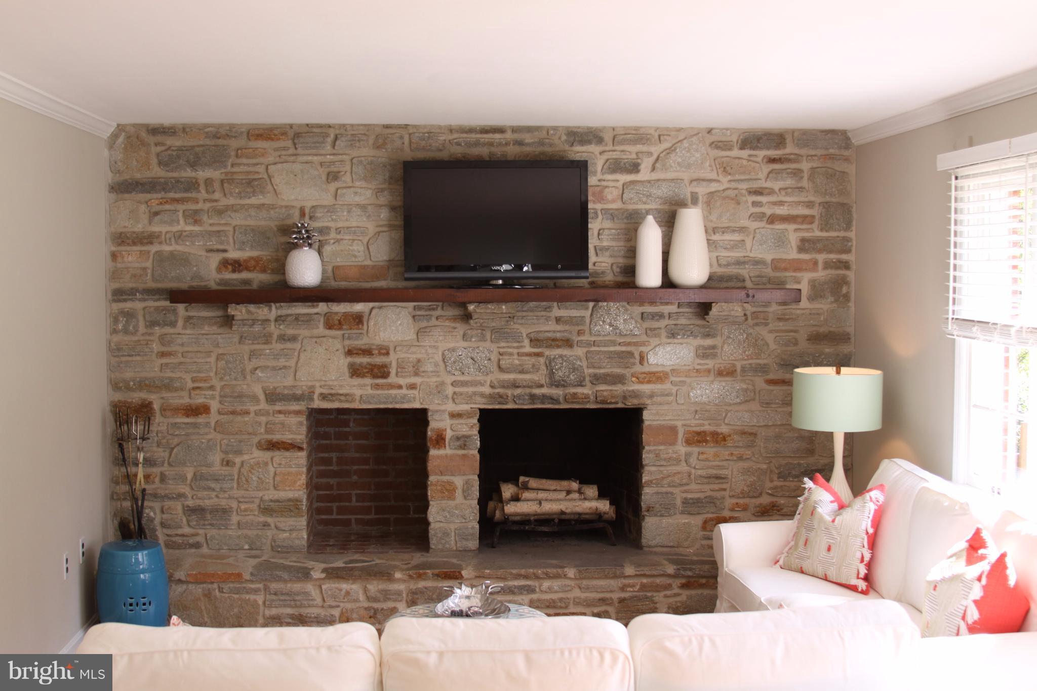 14220 Manor Road Phoenix, MD 21131 - Photo 15 of 25 a living room with furniture a flat screen tv and a fireplace