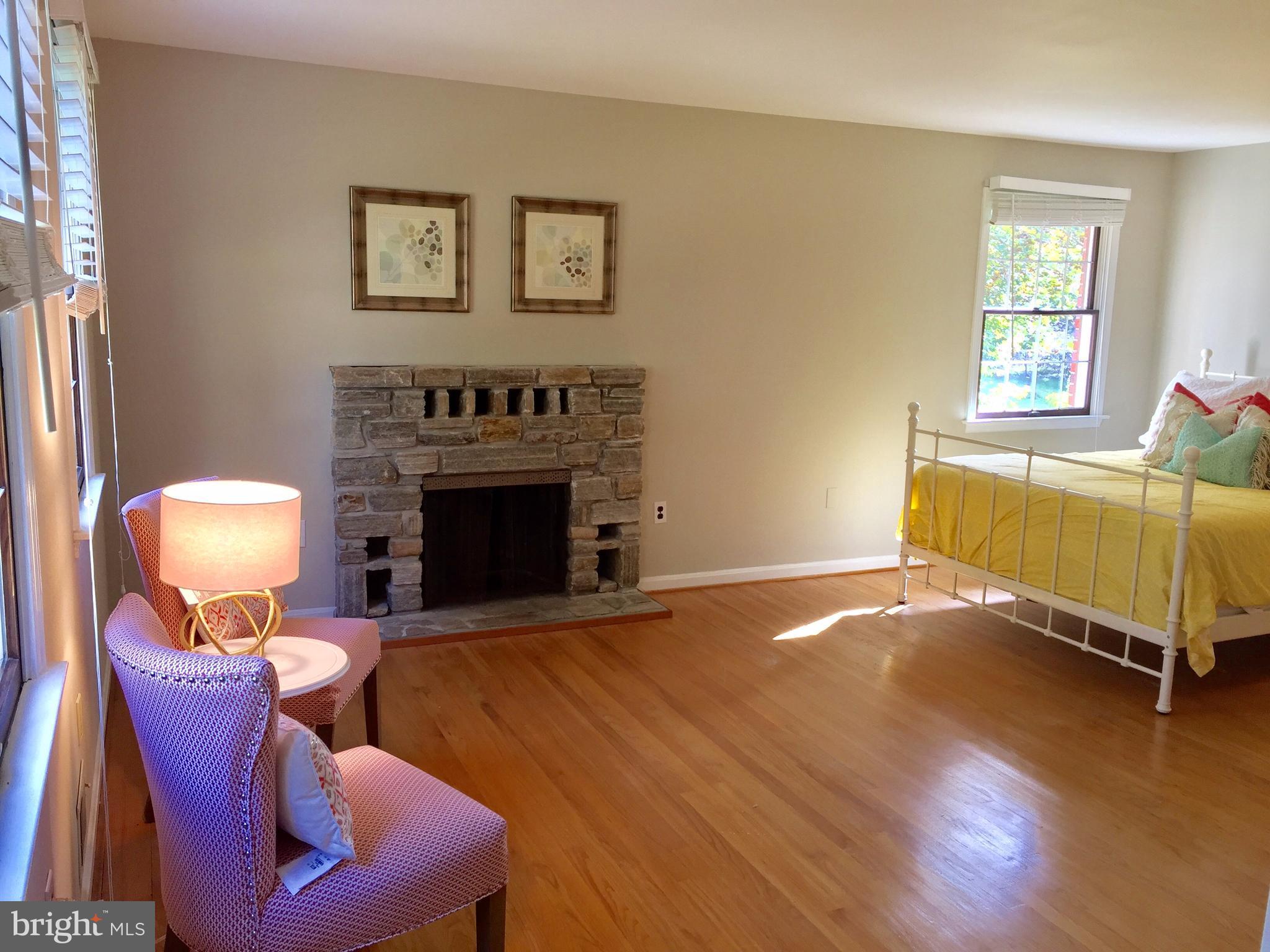 14220 Manor Road Phoenix, MD 21131 - Photo 22 of 25 a living room with furniture a fireplace and a window