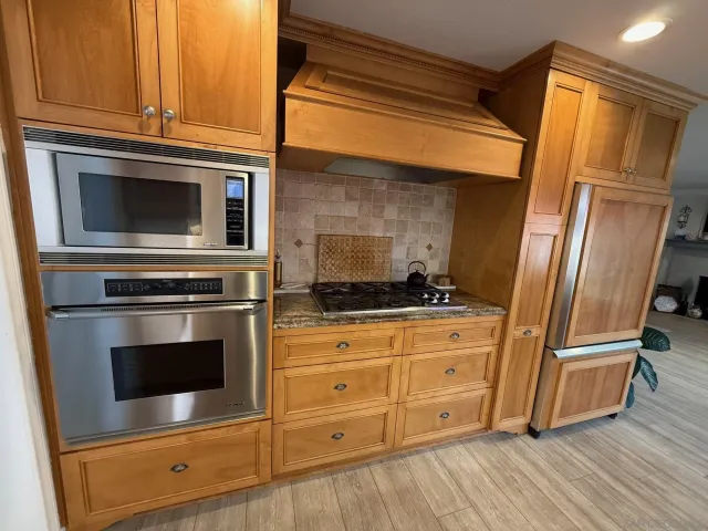 a patio with a table and chairs under an umbrella