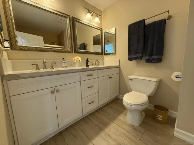 a front view of a house with a yard and potted plants