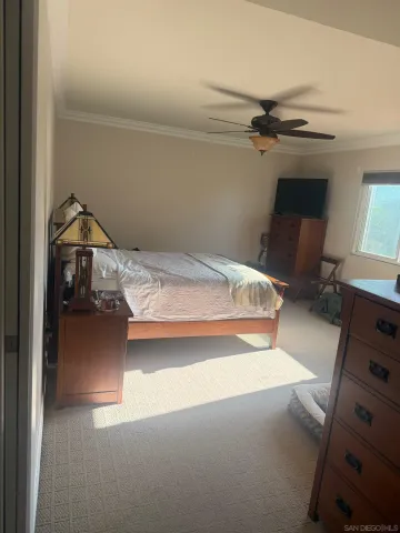 a backyard of a house with table and chairs under an umbrella