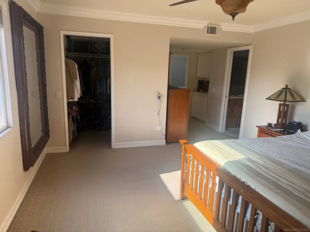 a front view of a house with a yard and potted plants