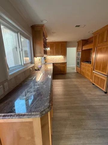 a bathroom with a toilet sink a mirror and vanity