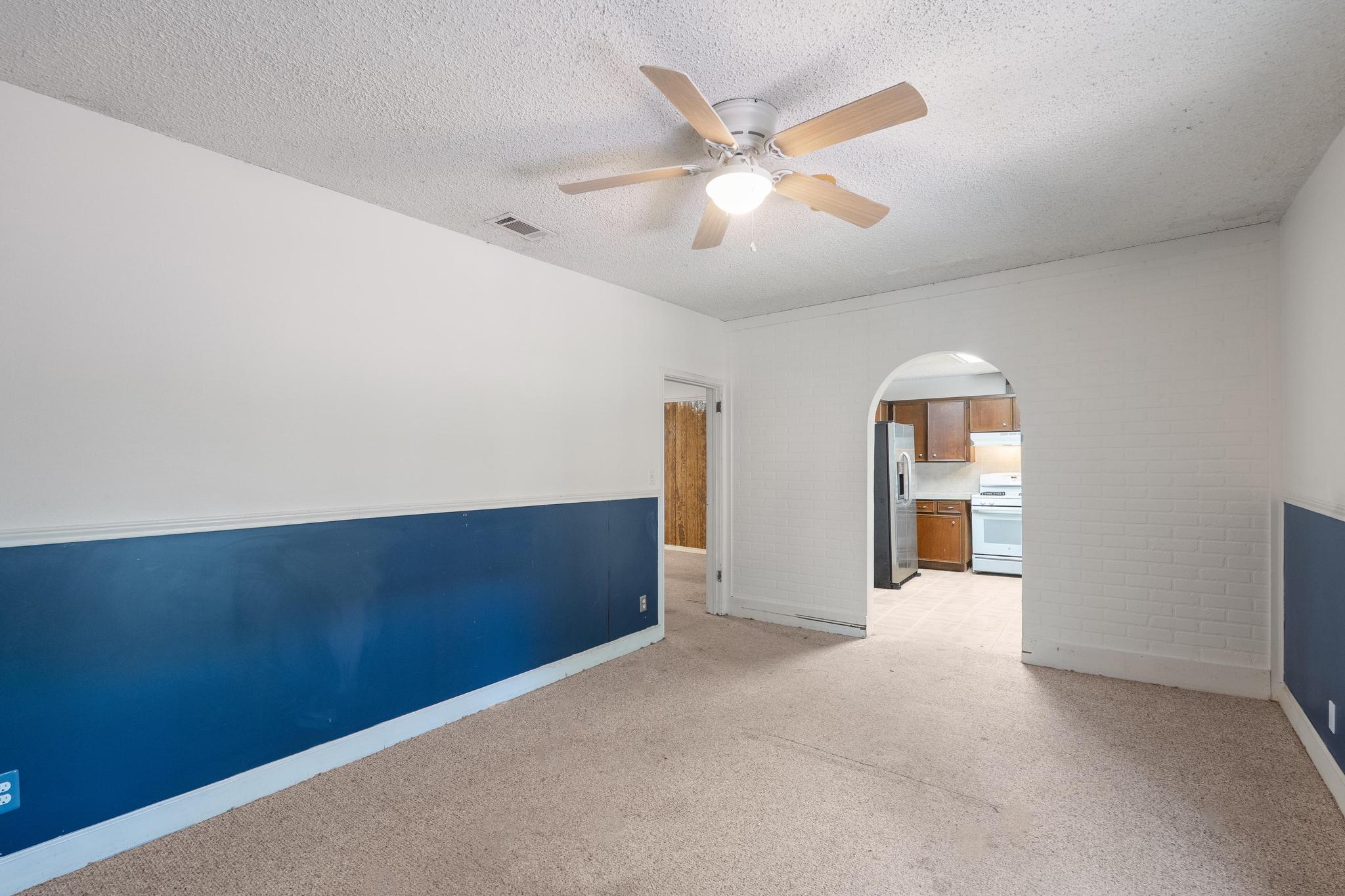 4616 East Cesar Chavez Street Austin, TX 78702 - Photo 12 of 22 an empty room with chandelier fan and windows