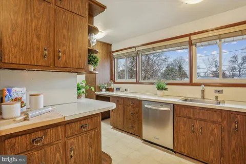 a kitchen with sink cabinets and wooden floor