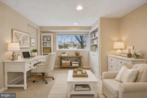 a living room with furniture a rug and a table