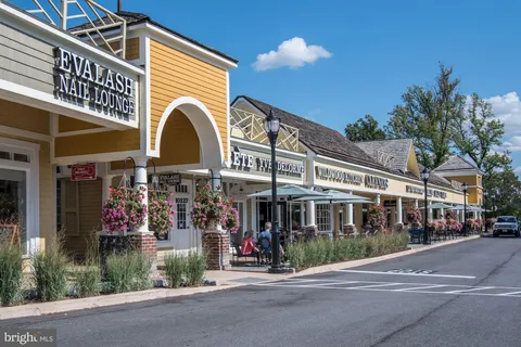 a view of street with shops and trees