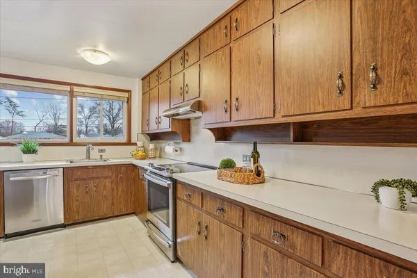 a kitchen with stainless steel appliances granite countertop a sink and cabinets