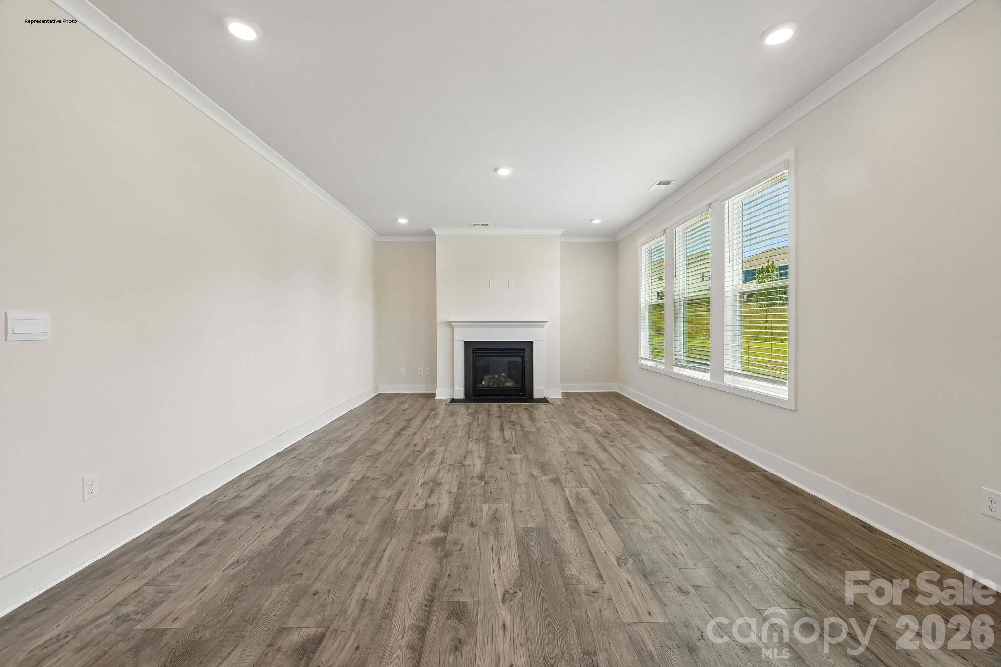 541 Mahogany Road York, SC 29745 - Photo 9 of 32 an empty room with wooden floor and windows