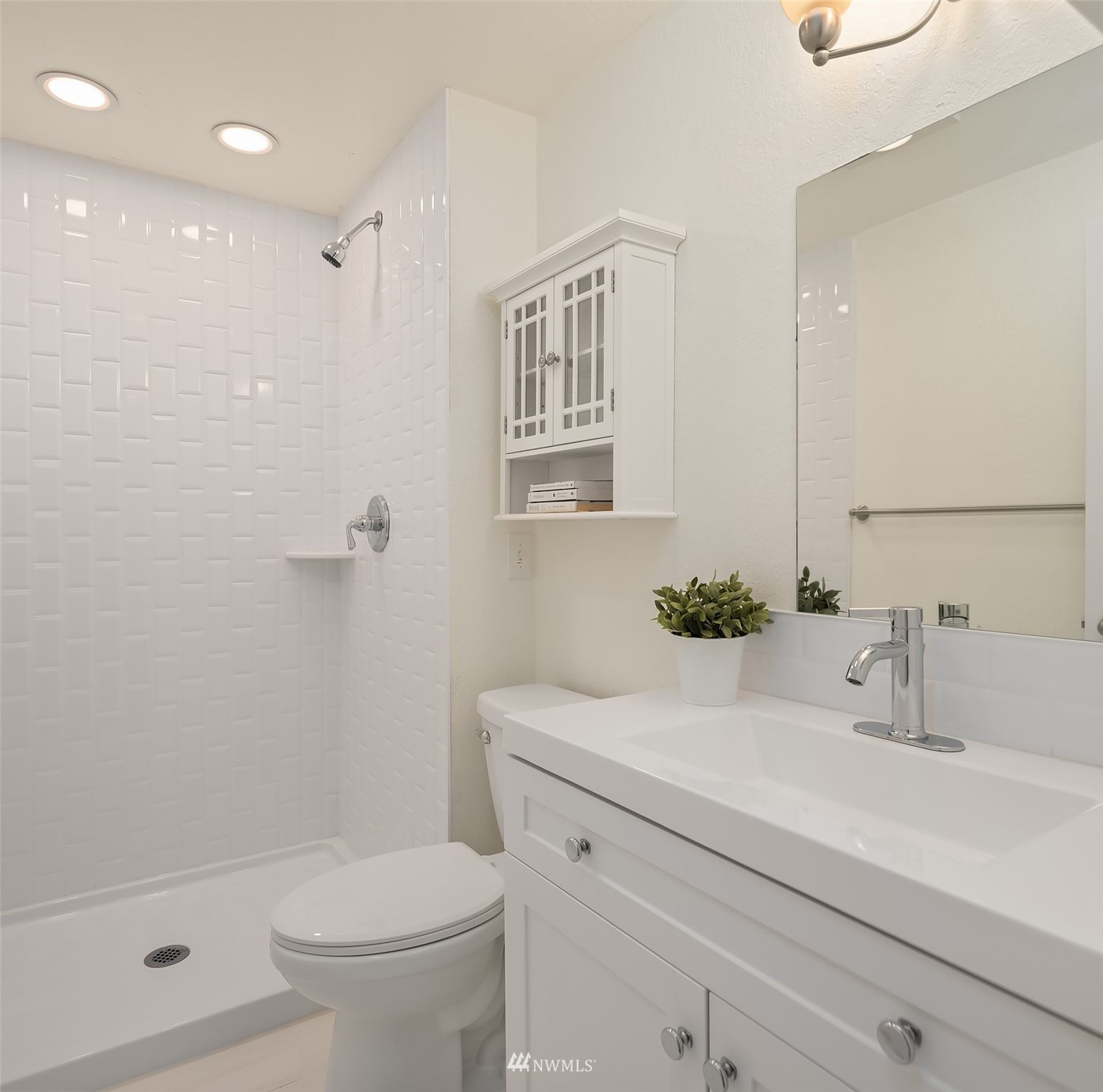 8418 240th Street Southwest, Unit A303 Edmonds, WA 98026 - Photo 12 of 23 a bathroom with a sink a toilet and shower