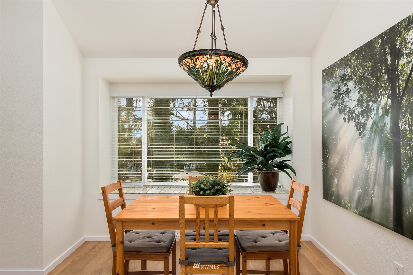 8418 240th Street Southwest, Unit A303 Edmonds, WA 98026 - Photo 15 of 23 a view of a dining room with furniture window and wooden floor
