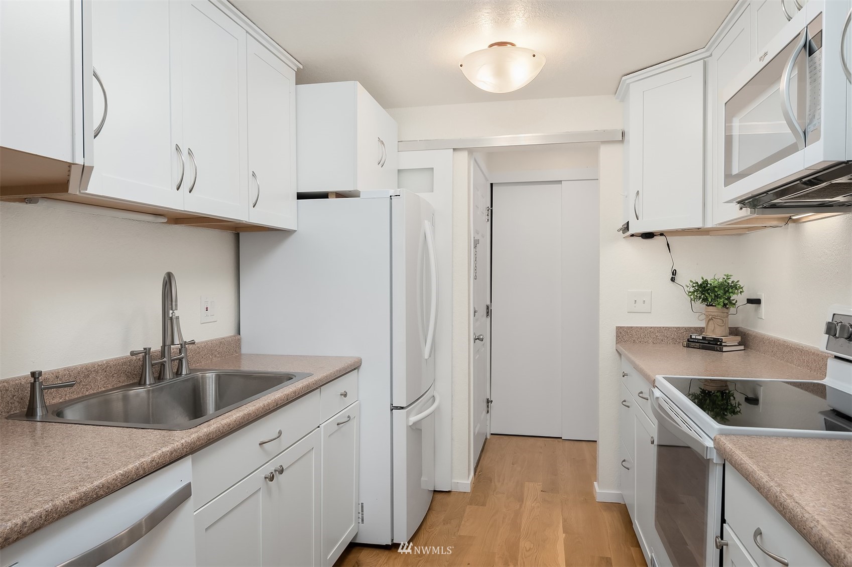 8418 240th Street Southwest, Unit A303 Edmonds, WA 98026 - Photo 6 of 23 a kitchen with stainless steel appliances granite countertop a sink stove and cabinets