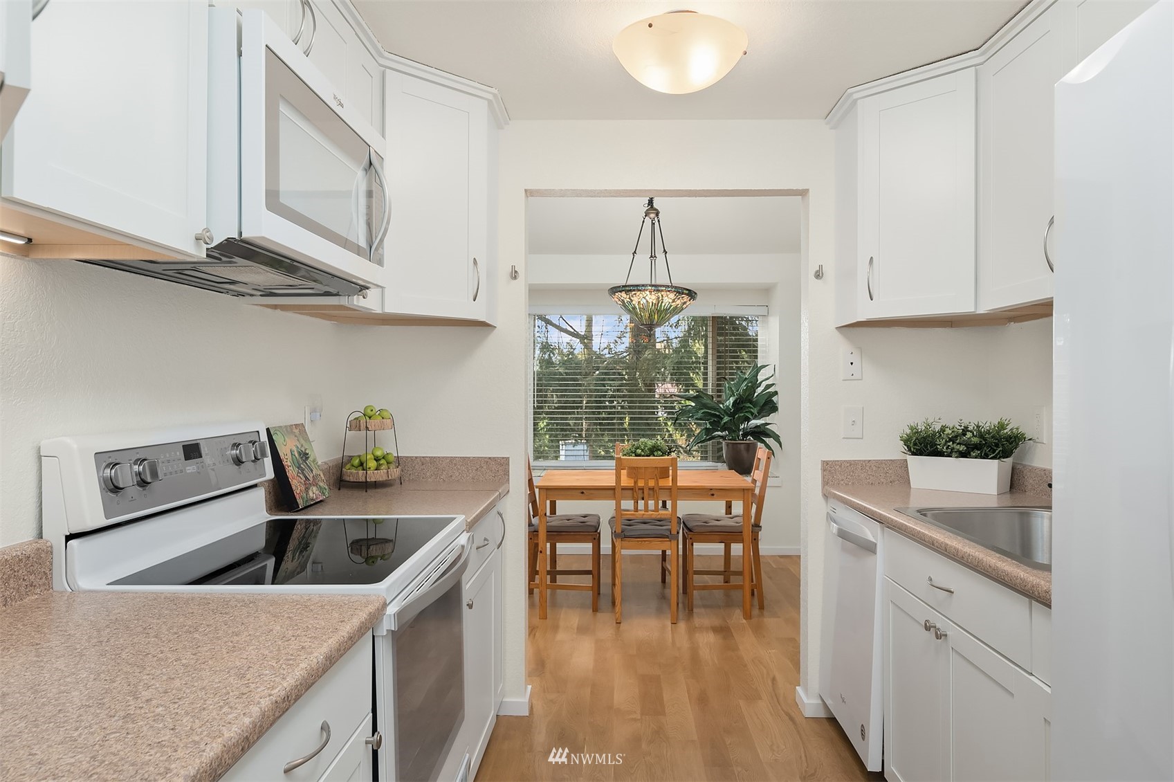 8418 240th Street Southwest, Unit A303 Edmonds, WA 98026 - Photo 7 of 23 a kitchen that has a lot of cabinets in it