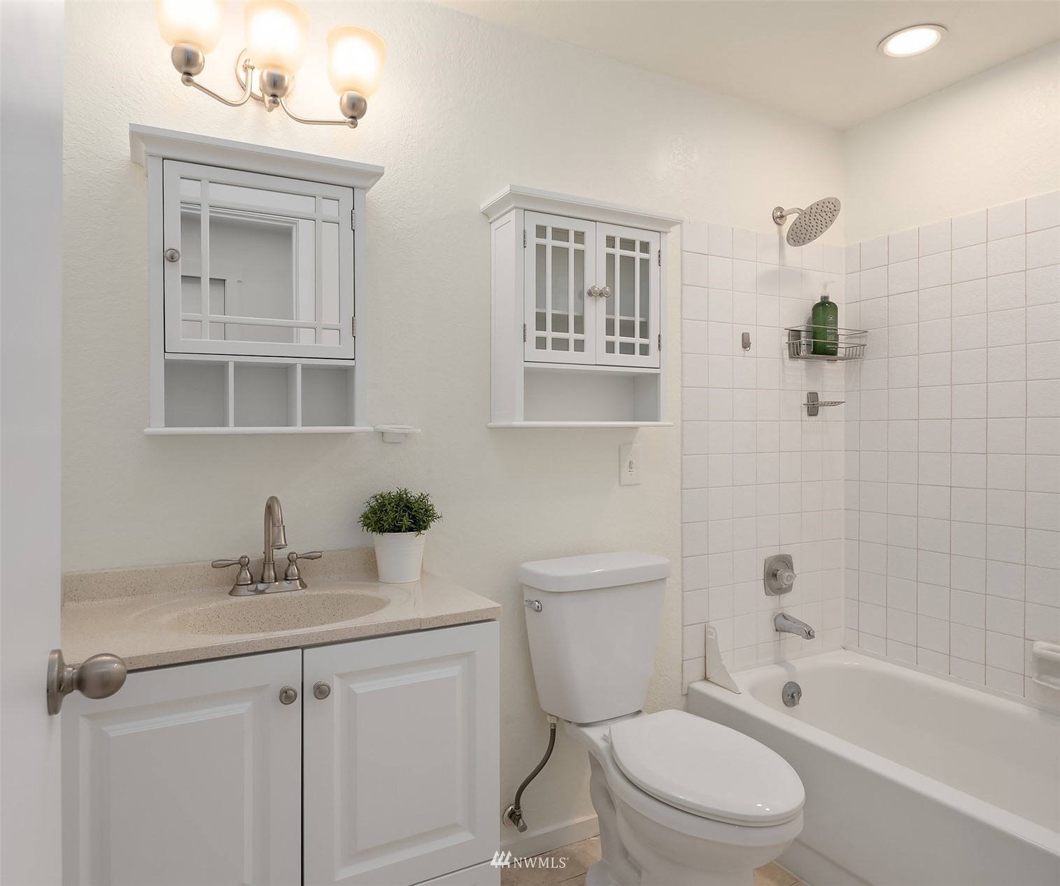 8418 240th Street Southwest, Unit A303 Edmonds, WA 98026 - Photo 10 of 23 a bathroom with a sink a toilet and shower