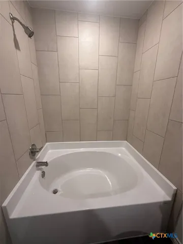 a bathroom with a white bath tub