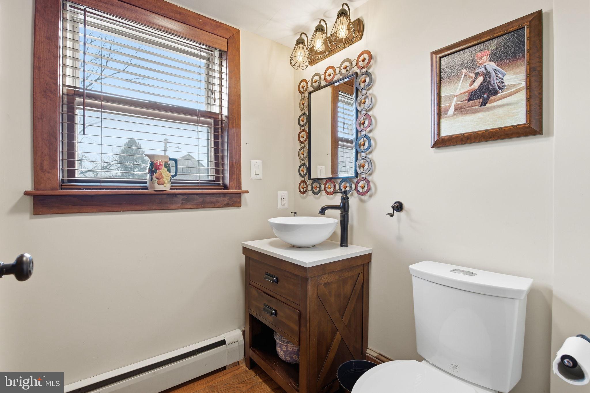 21627 Gunpowder Road Manchester, MD 21102 - Photo 19 of 32 a bathroom with a toilet a sink and a mirror