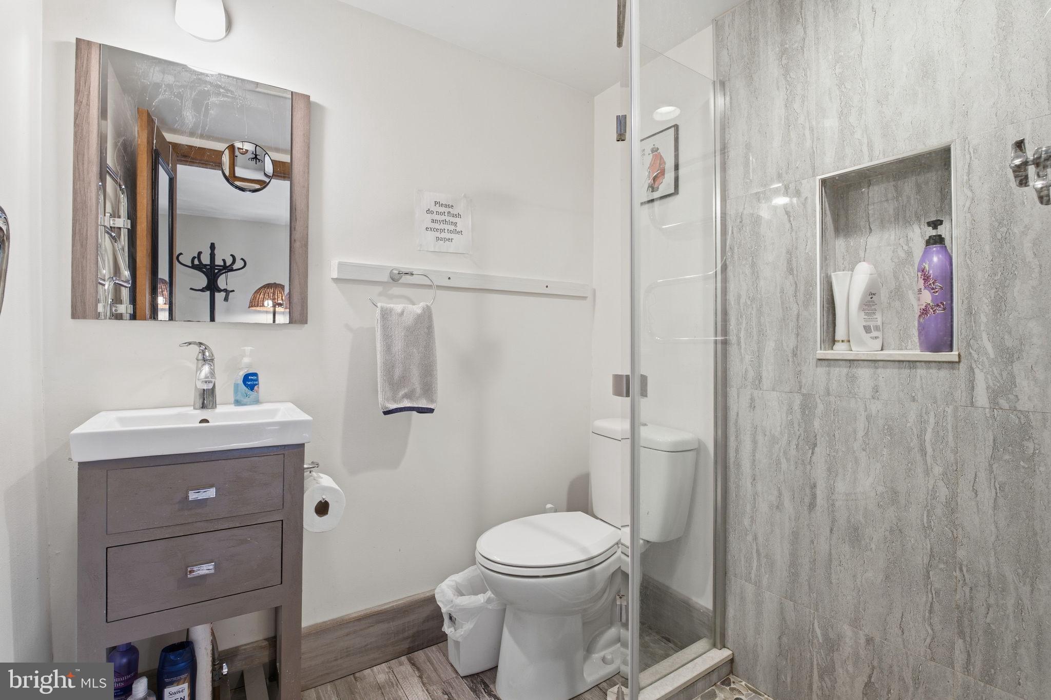 21627 Gunpowder Road Manchester, MD 21102 - Photo 23 of 32 a bathroom with a toilet a sink and mirror