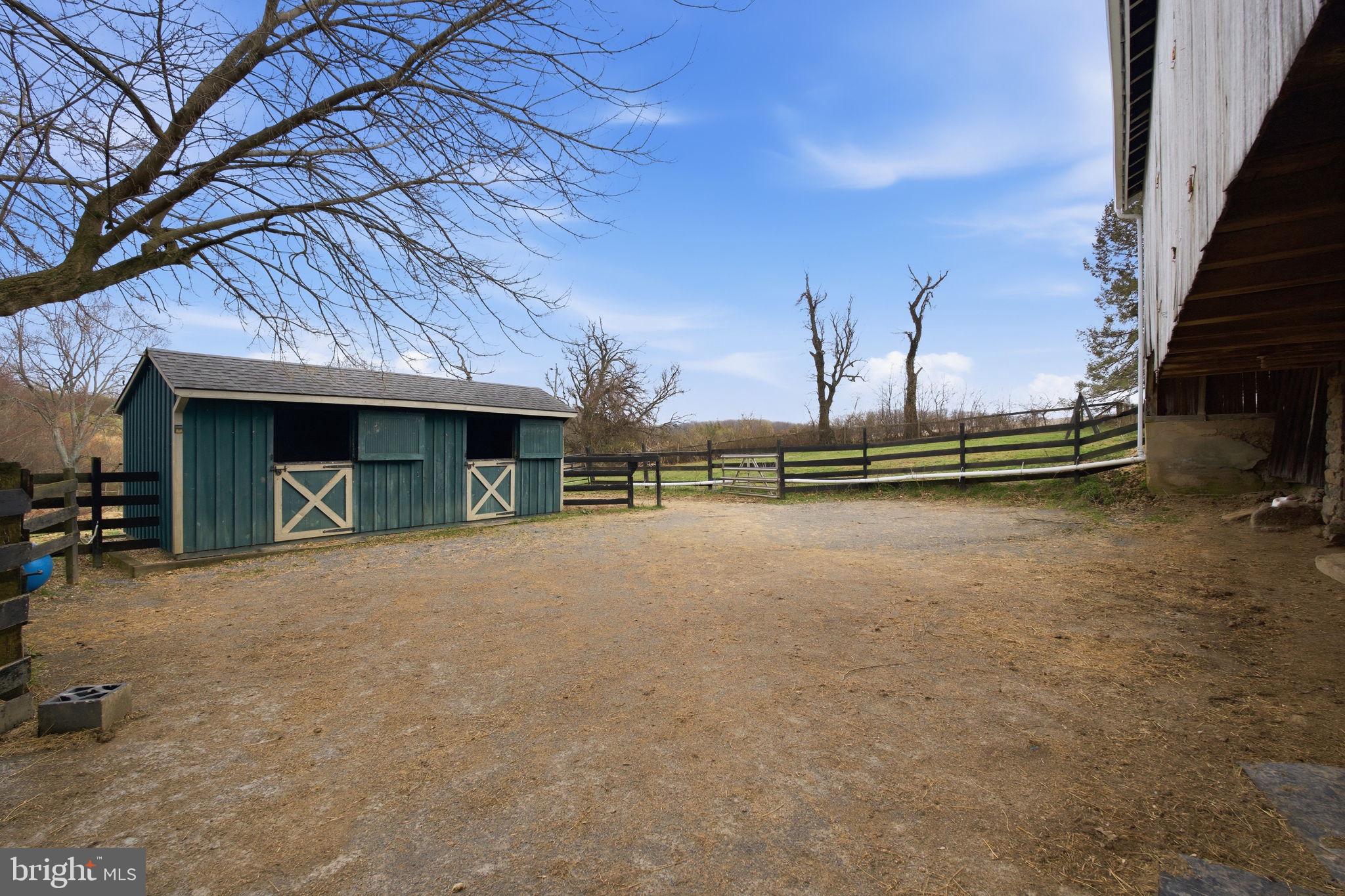 21627 Gunpowder Road Manchester, MD 21102 - Photo 28 of 32 a view of a terrace with a table and chairs under an umbrella