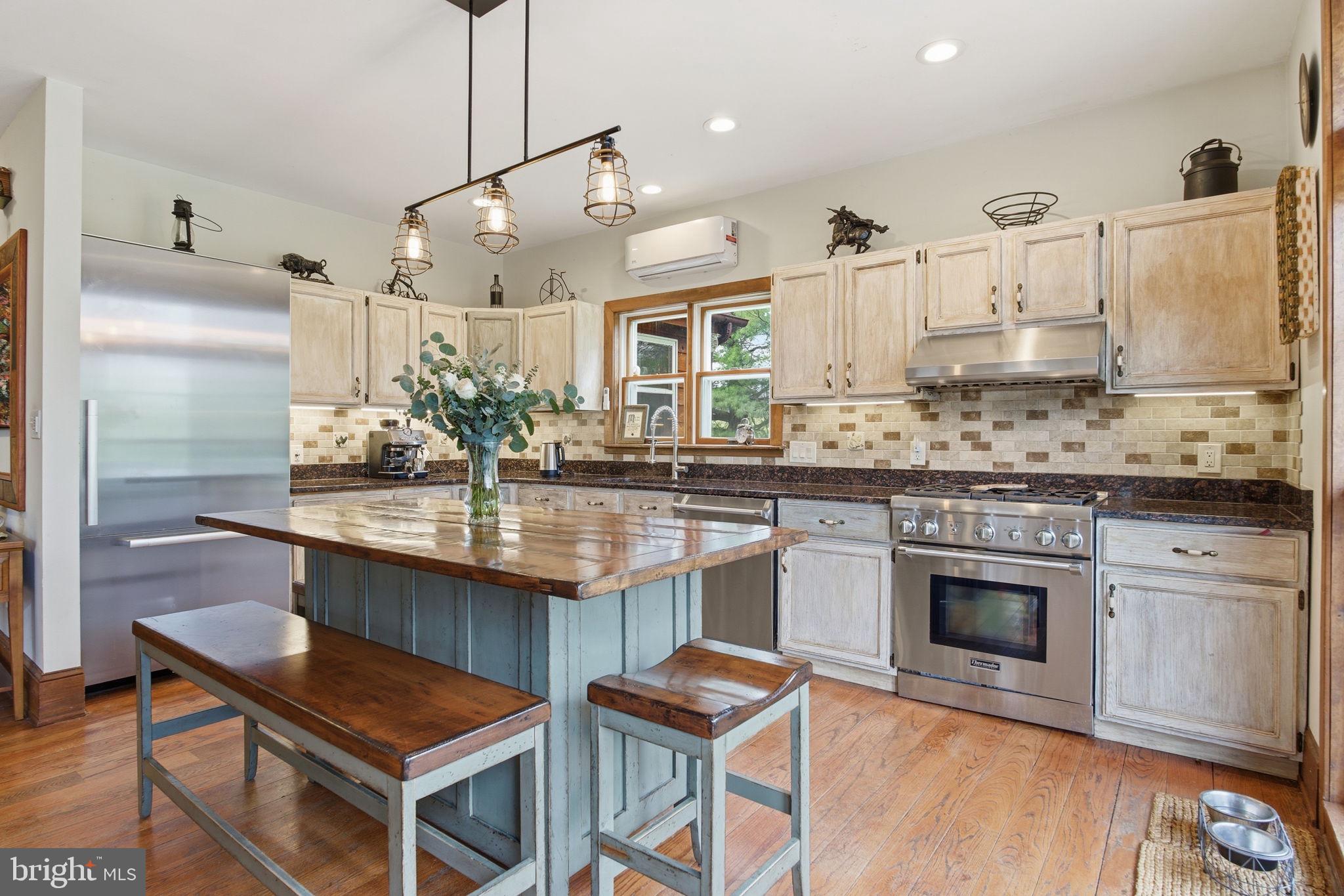 21627 Gunpowder Road Manchester, MD 21102 - Photo 5 of 32 a kitchen with kitchen island granite countertop a sink cabinets and stainless steel appliances