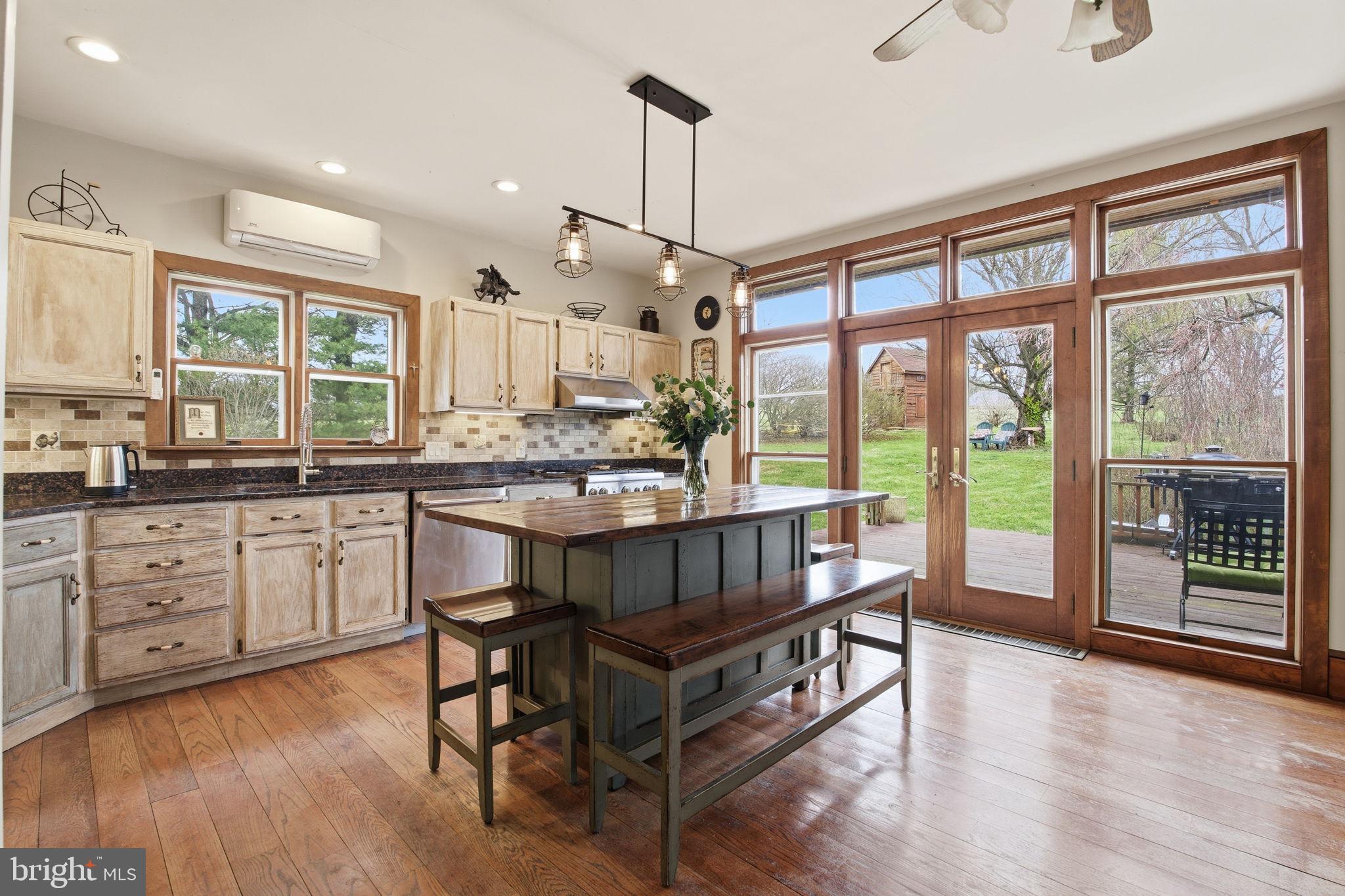 21627 Gunpowder Road Manchester, MD 21102 - Photo 6 of 32 a kitchen with a table chairs stove and wooden floor