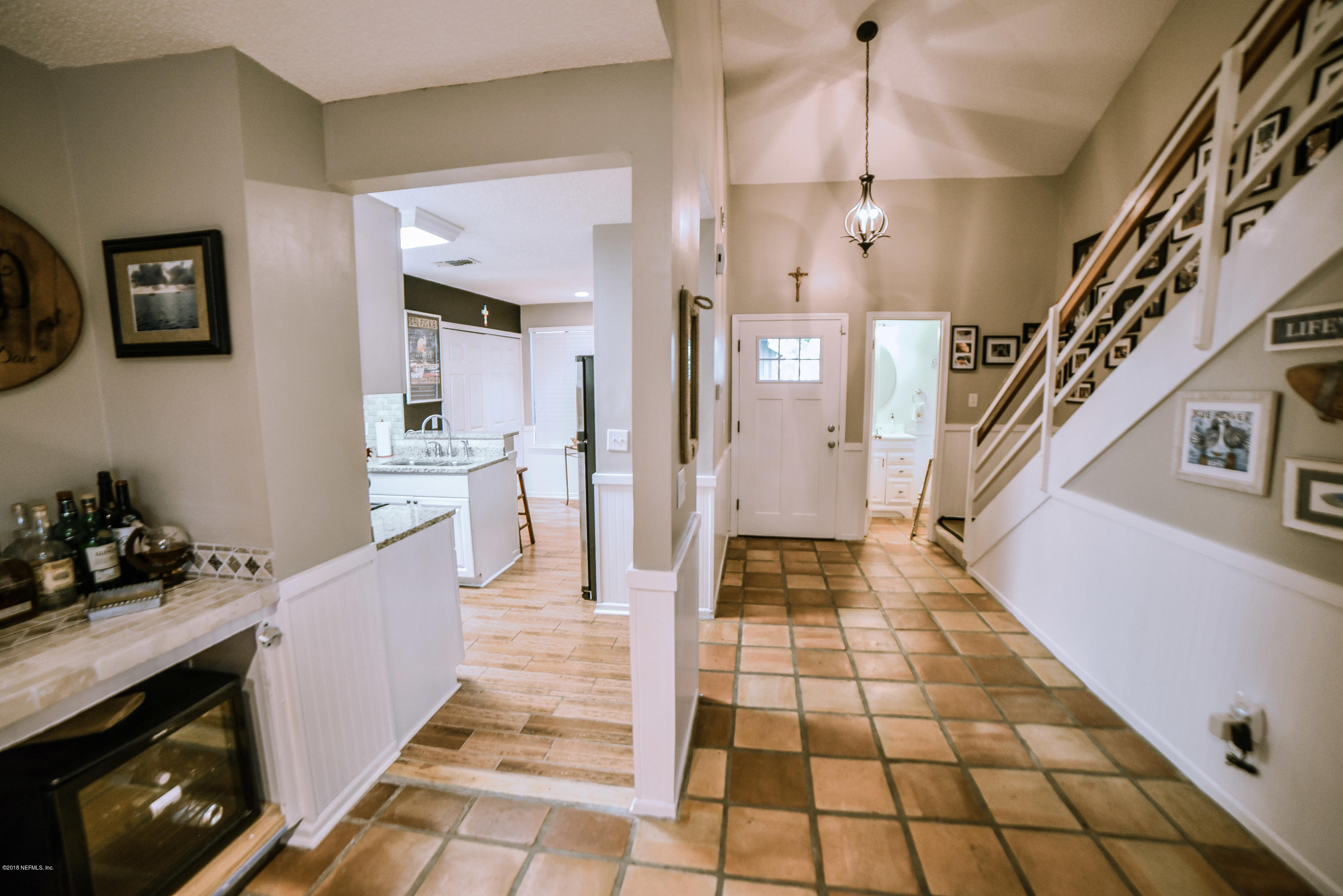 1 Turtleback Trail Ponte Vedra Beach, FL 32082 - Photo 4 of 23 a hallway with white cabinets and black chairs