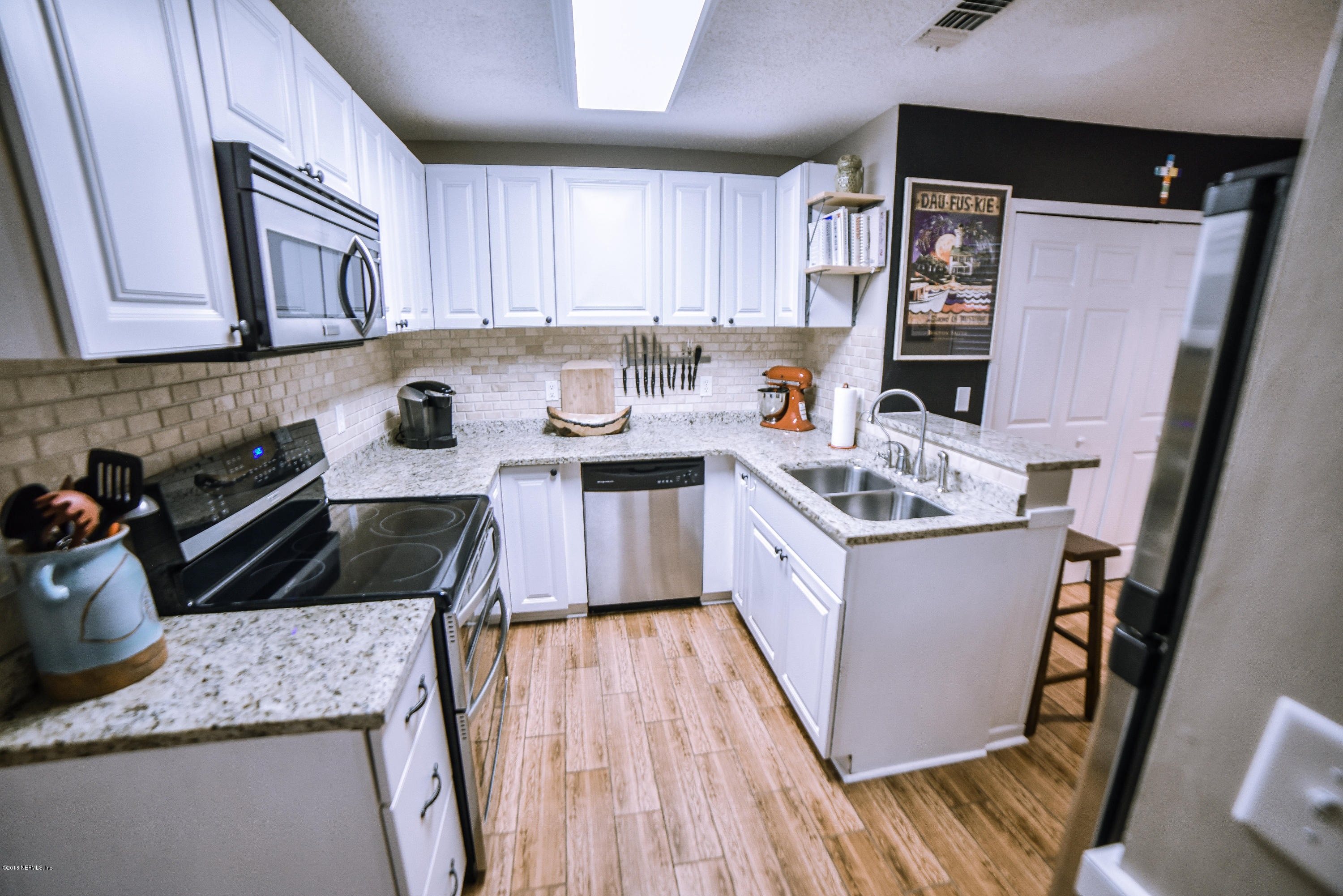 1 Turtleback Trail Ponte Vedra Beach, FL 32082 - Photo 7 of 23 a kitchen with a sink stove and cabinets