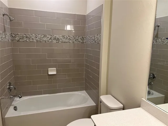 a bathroom with a bathtub and toilet