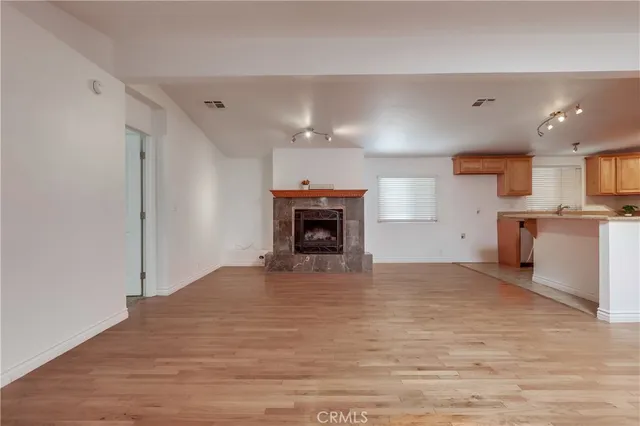 a view of kitchen with wooden floor and electronic appliances