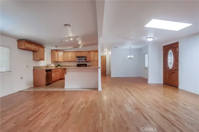 a kitchen with a refrigerator and a stove top oven