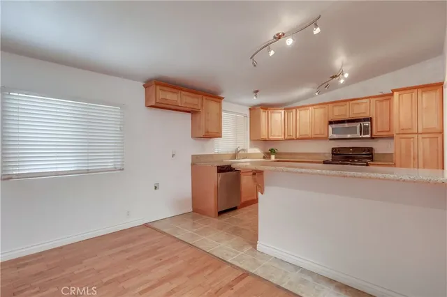 a kitchen with granite countertop a sink and a stove