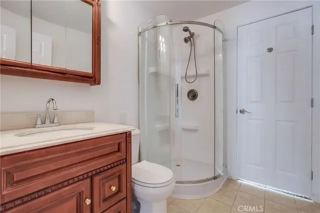 an empty room with chandelier fan and windows