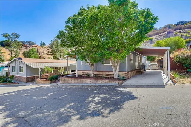 a view of city street with a building and trees in the background