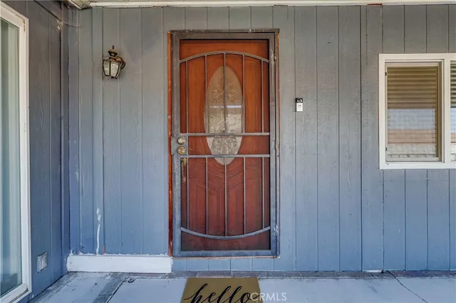 a view of empty room with wooden floor and fireplace