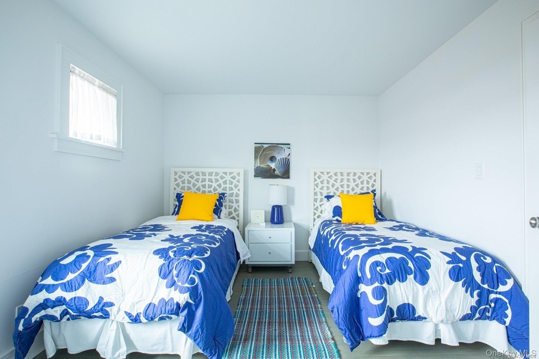 11 Captree Island Babylon, NY 11702 - Photo 26 of 31 a bedroom with two beds and a lamp