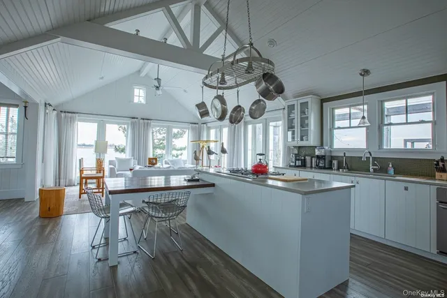 a kitchen with counter space dining table and chairs