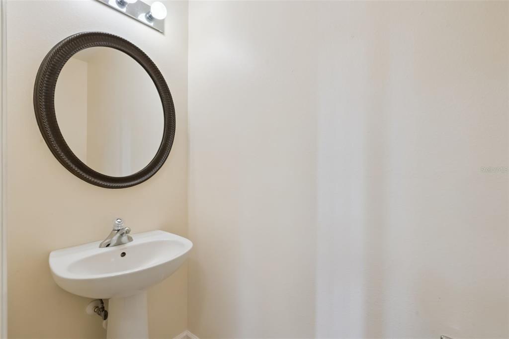 1400 Celebration Avenue, Unit 305 Celebration, FL 34747 - Photo 11 of 38 a bathroom with a sink and a mirror