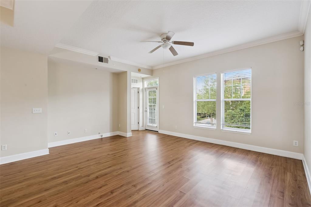 1400 Celebration Avenue, Unit 305 Celebration, FL 34747 - Photo 17 of 38 a view of an empty room with wooden floor and a window