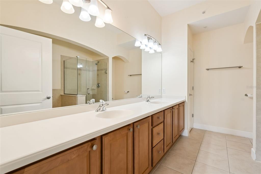 1400 Celebration Avenue, Unit 305 Celebration, FL 34747 - Photo 25 of 38 a bathroom with a double vanity sink mirror and a bathtub