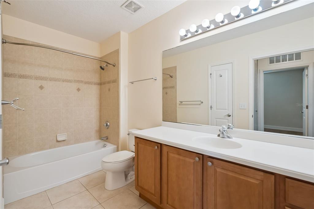 1400 Celebration Avenue, Unit 305 Celebration, FL 34747 - Photo 29 of 38 a bathroom with a sink a toilet and shower