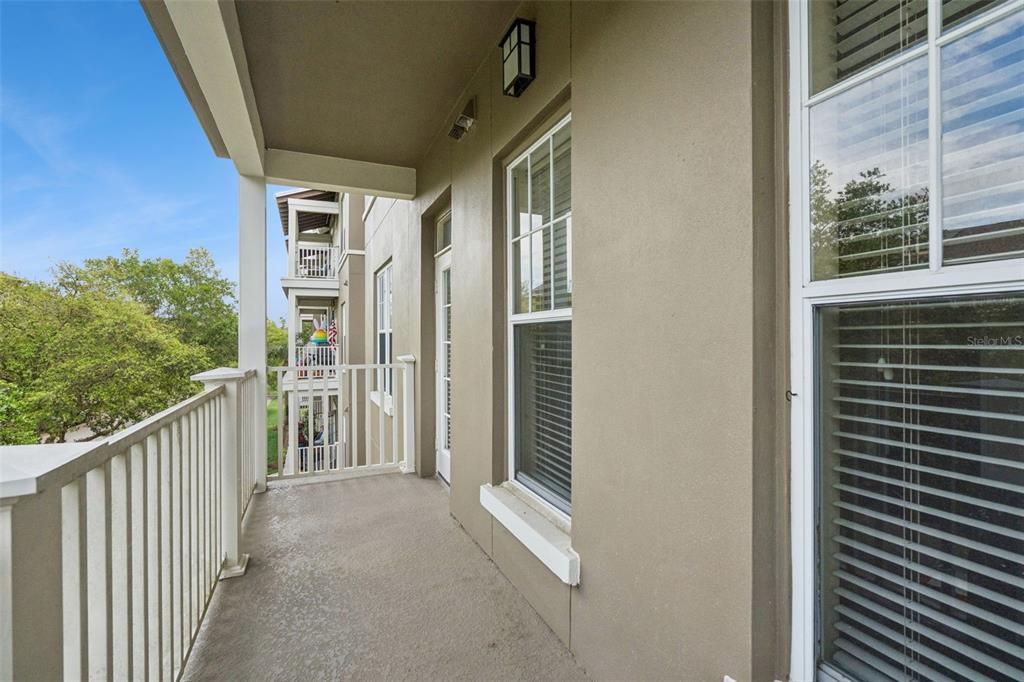 1400 Celebration Avenue, Unit 305 Celebration, FL 34747 - Photo 31 of 38 a view of a porch with wooden floor and outdoor space