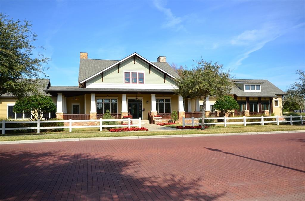 1400 Celebration Avenue, Unit 305 Celebration, FL 34747 - Photo 36 of 38 a front view of a building with small garden and plants