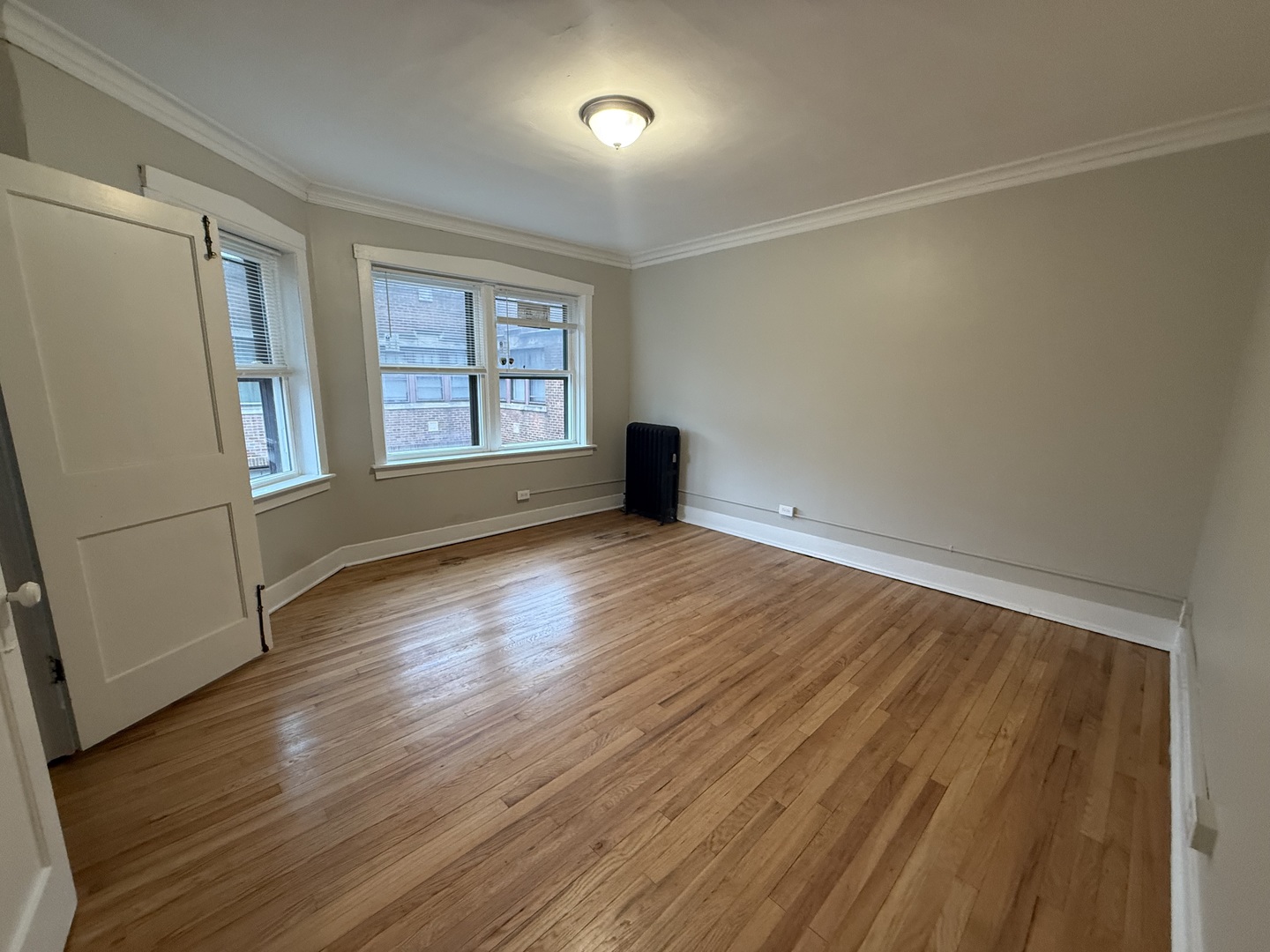 106 Lincoln Avenue, Unit 3W Riverside, IL 60546 - Photo 2 of 10 an empty room with wooden floor and windows